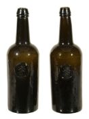 A pair of H. Ricketts & Co. Glassworks Bristol sealed wine bottles  A pair of H. Ricketts  &  Co.