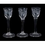 A set of three engraved plain-stemmed wine glasses, mid 18th century  A set of three engraved