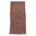 A Karabagh long rug, the navy field decorated throughout with an overall...  A Karabagh long