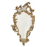 A carved giltwood and composition wall mirror in George III style  A carved giltwood and composition