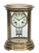 A French champleve enamelled brass oval four glass mantel clock  A French champleve enamelled