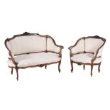 A carved walnut sofa and matching tub armchair in Louis XV style  A carved walnut sofa and