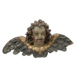 An Italian carved, painted and parcel giltwood winged cherub head  An Italian carved, painted and