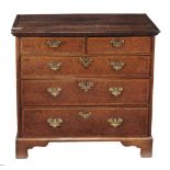 A George II oak and burr wood chest of drawers , circa 1750  A George II oak and burr wood chest