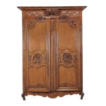A Louis XV carved oak armoire, circa 1750, possibly Normandy  A Louis XV carved oak armoire,   circa