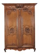 A Louis XV carved oak armoire, circa 1750, possibly Normandy  A Louis XV carved oak armoire,   circa