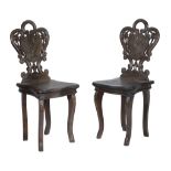 A pair of 'Black Forest' carved and stained wood children's chairs  A pair of 'Black Forest'