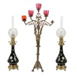 A pair of Continental porcelain and gilt metal mounted table oil lamps  A pair of Continental