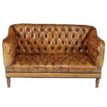 A button upholstered leather sofa, late 19th/ early 20th century  A button upholstered leather sofa,