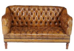 A button upholstered leather sofa, late 19th/ early 20th century  A button upholstered leather sofa,