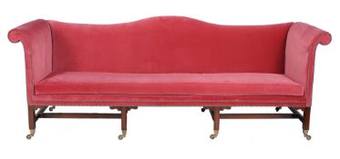 A pair of mahogany and upholstered sofas in George III style