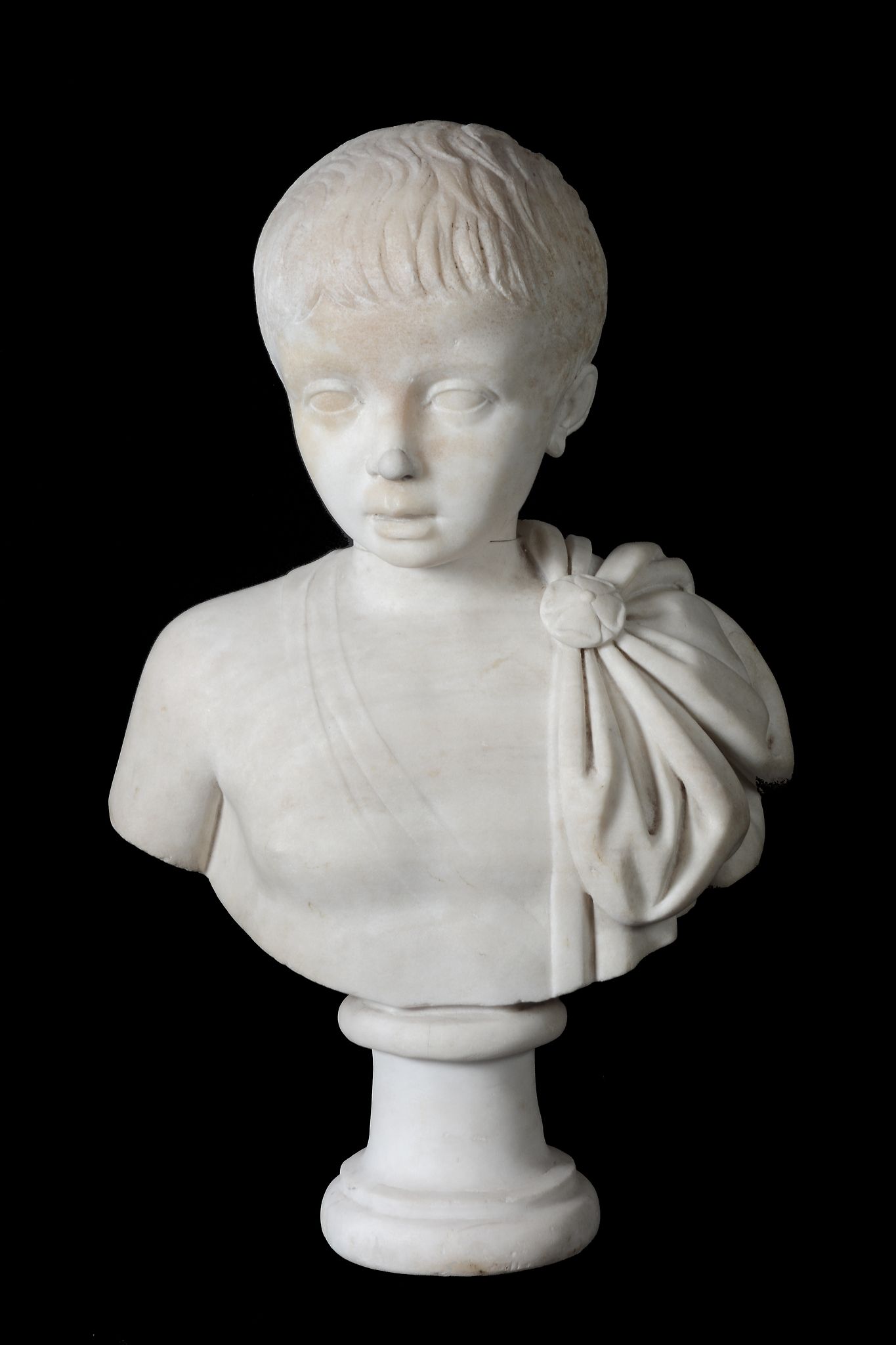 An Imperial Roman sculpted marble head of a young boy, circa 1st Century A.D