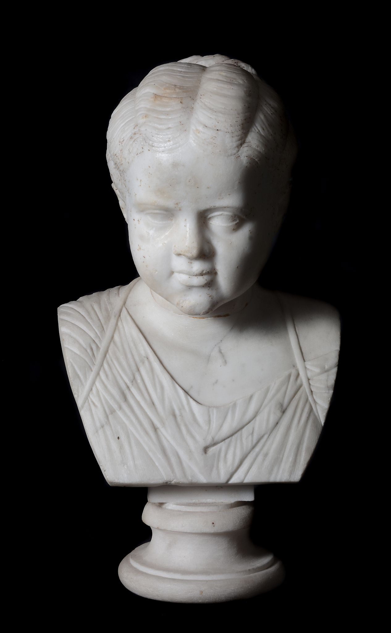 An Imperial Roman sculpted marble head of a girl, 1st - early 2nd Century A.D