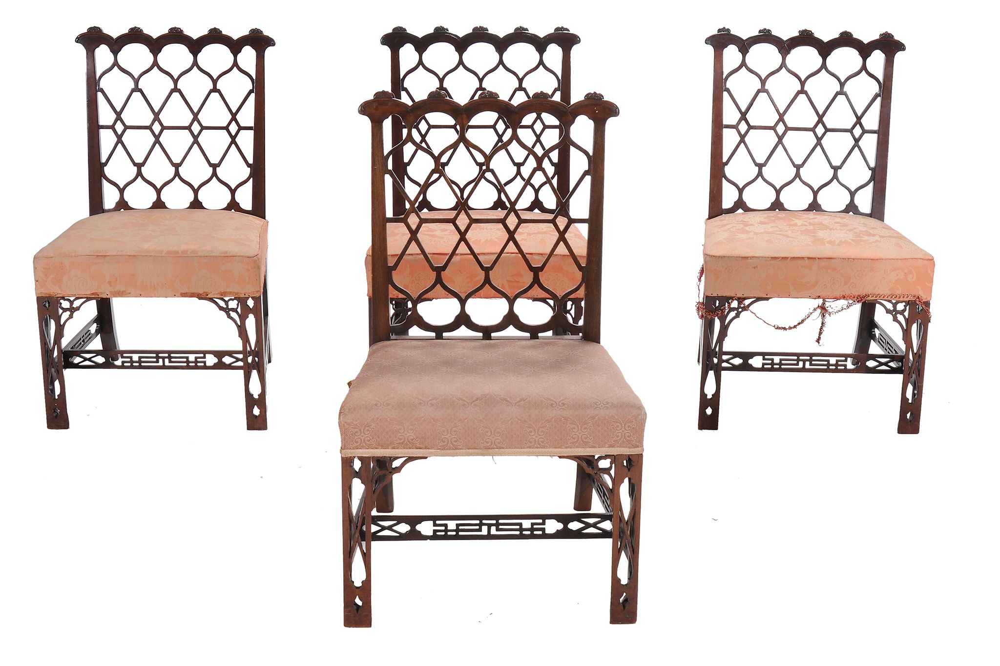 A set of four George III mahogany chairs, circa 1800, after a design by Thomas Chippendale, each