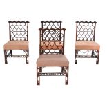A set of four George III mahogany chairs, circa 1800, after a design by Thomas Chippendale, each
