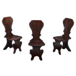 A set of three George II mahogany hall chairs, circa 1750