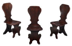 A set of three George II mahogany hall chairs, circa 1750