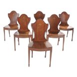 A set of six George III mahogany hall chairs, circa 1790
