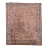 A Sarouk carpet, decorated in polychrome with scrolling floral foliage on a...