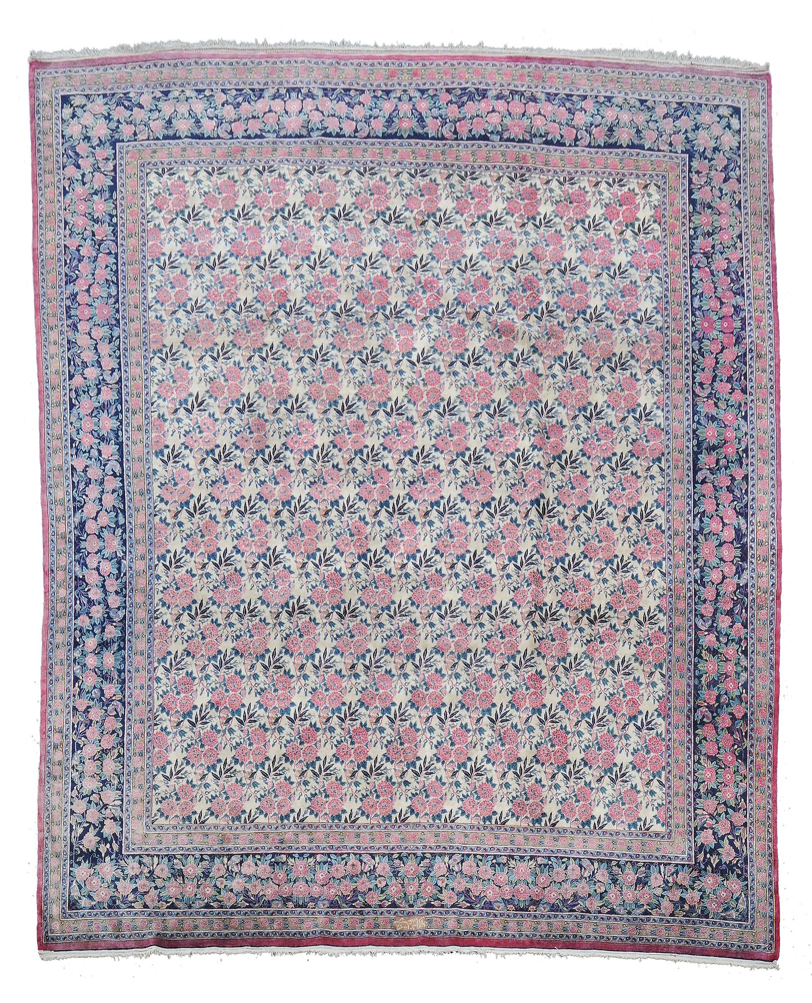 A Sarouk carpet, the cream field decorated with an overall repeated design...