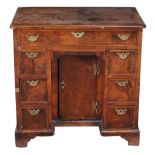 A George II walnut kneehole desk, circa 1735