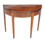 A George III mahogany and tulipwood crossbanded semi elliptical card table