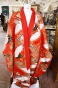 A Japanese wedding kimono, red ground decorated with herons