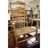 An ash ladder back chair with rush seat and a smaller ash child's chair similar.