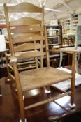 An ash ladder back chair with rush seat and a smaller ash child's chair similar.