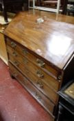 A George III mahogany bureau, with fitted interior and four long graduated drawers on bracket feet