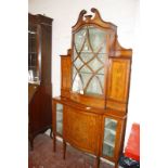 An Edwardian Sheraton Revival satinwood display cabinet with floral swag inlay, having a broken swan