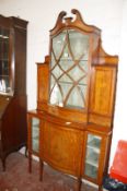 An Edwardian Sheraton Revival satinwood display cabinet with floral swag inlay, having a broken swan