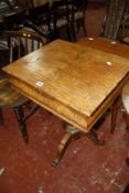 A 19th century walnut and marquetry work table on column support and splayed legs.
