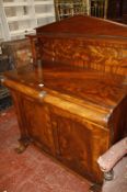 A William IV mahogany chiffonier, with raised arched back, two moulded drawers with panelled doors