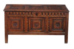 A Charles II oak coffer, circa 1660, the rectangular triple panel lid, with an arcaded frieze, above