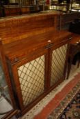 A late Victorian mahogany chiffonier with a brass gallery to the shelf and twin panelled cupboards