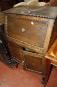 A small Georgian style oak bureau with hinged top.(lacking an interior)