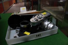 A Leica M3 three single stroke camera and lens, a Leica lightmeter, a close up rangefinder, a hood