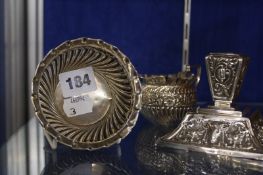 A Victorian squat silver candlestick, with repousse decoration, tapered base, Birmingham 1892, a