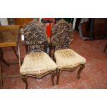 A companion pair of 19th Century parcel gilt decorated carved Continental chairs