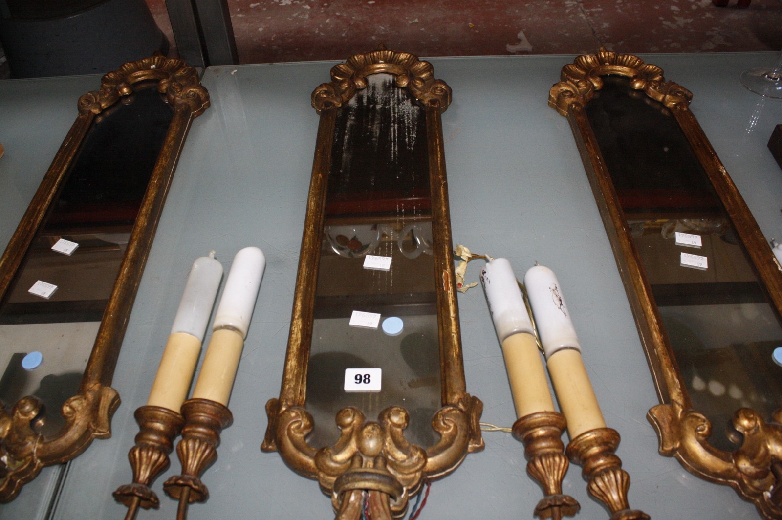 Three gilt composition twin light girandoles, 77cm long