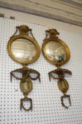 A pair of George III style giltwood wall mirrors surmounted with urns with ram's mask handles 88cm