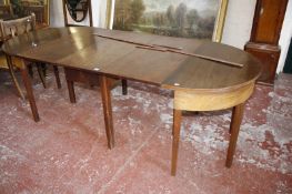 A 19th century mahogany D-end dining table with drop leaf centre section and two later D-ends.