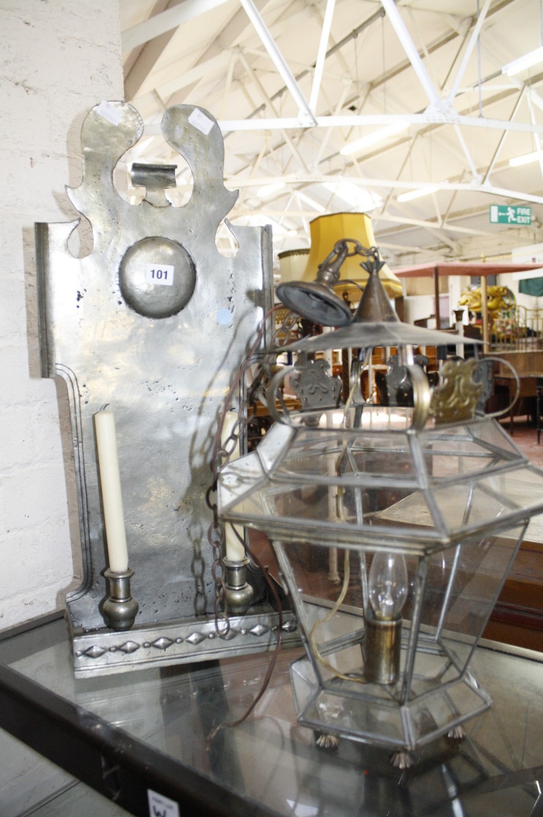 A glazed lantern and a metal wall sconce with twin candleholders