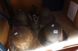 Four WWII Army helmets and two blow torches