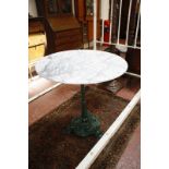 A cast iron based marble topped table.