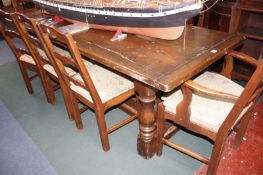 An oak refectory table on column turned supports with a uniting cross stretcher.224cm x 84cm.