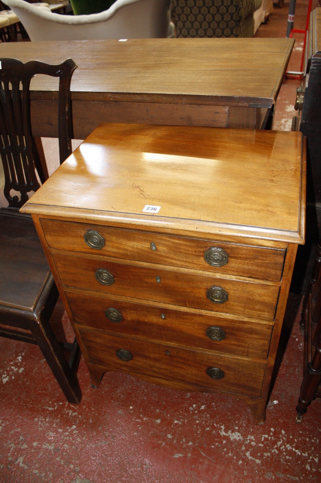 A small chest of drawers and a reproduction canterbury.