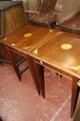 A pair of mahogany lamp tables with satinwood spandrel to the center.