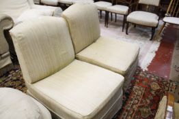 A pair of low, square back easy chairs